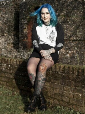 yasmin ellis sitting on a brick wall